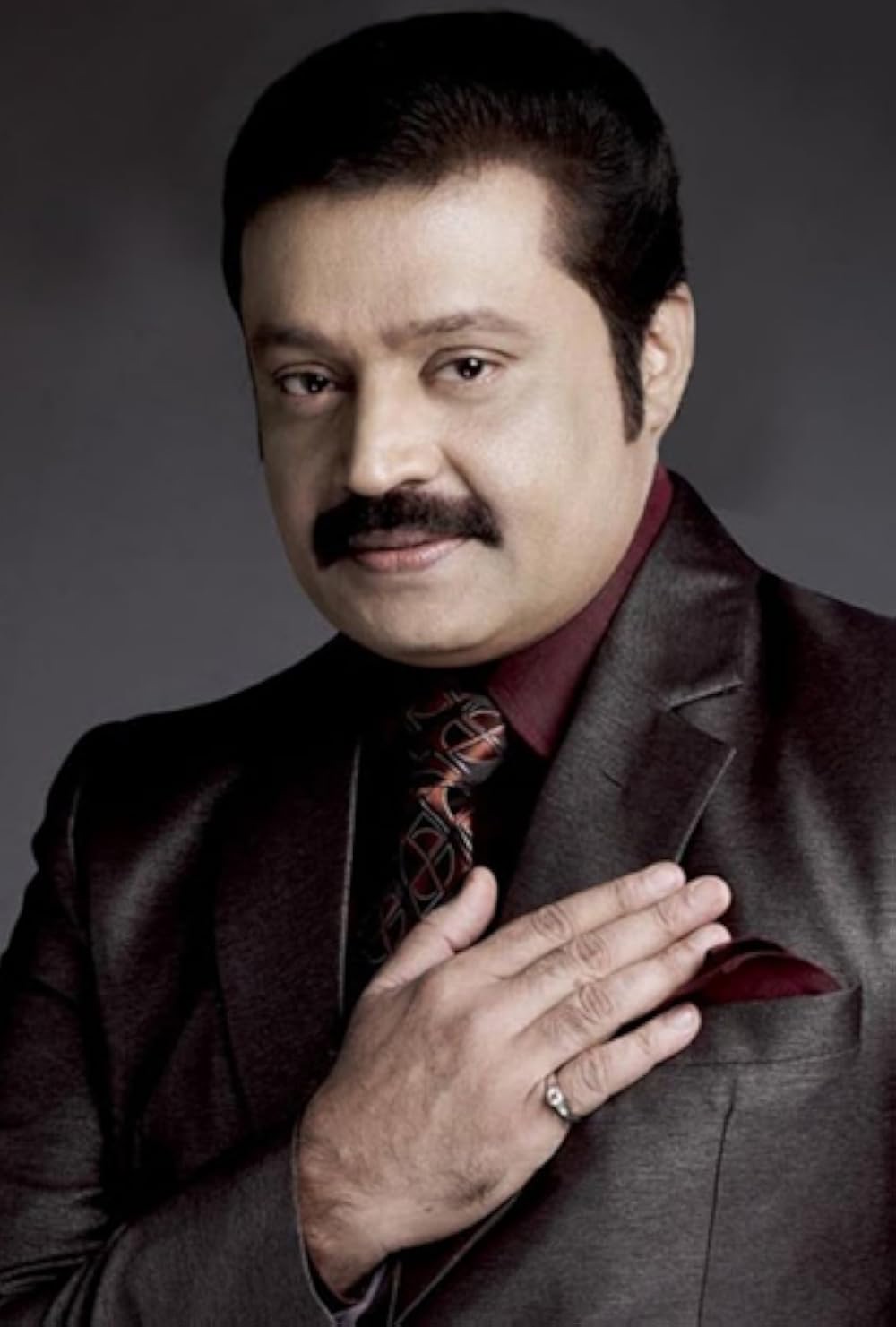 Studio portrait of Suresh Gopi in a dark suit
