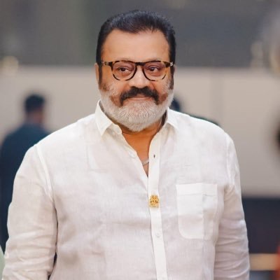 Portrait of Suresh Gopi in a white shirt and spectacles
