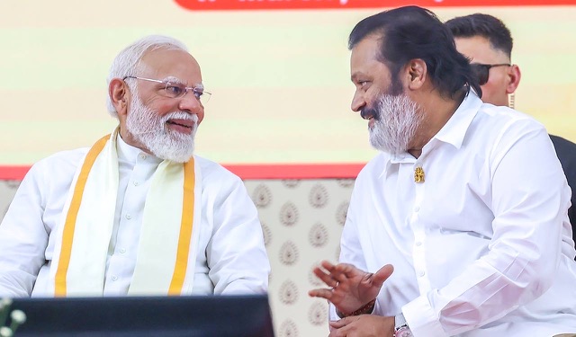 Suresh Gopi seated in conversation with Prime Minister Narendra Modi at a public event