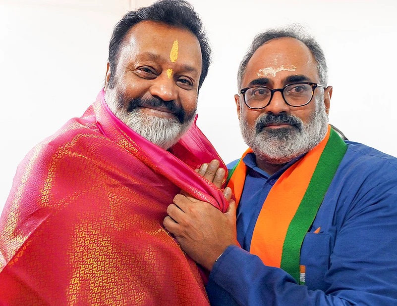 Suresh Gopi, wearing a ceremonial shawl, with Rajeev Chandrasekhar