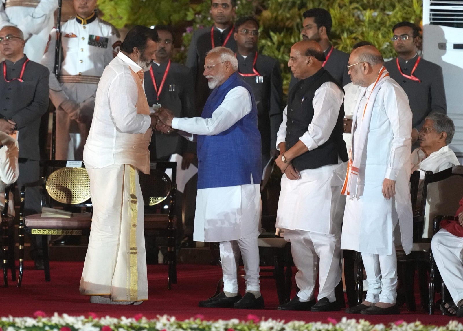Suresh Gopi greeting Prime Minister Narendra Modi at the swearing-in ceremony of the Union Council of Ministers, with Rajnath Singh and Amit Shah standing alongside
